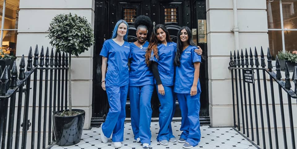 Sofwave ultrasound skin lifting Dublin - four nurses in blue scrubs outside a Georgian Four nurses in blue scrubs outside a Georgian clinic entrance, Sofwave ultrasound skin lifting Dublin