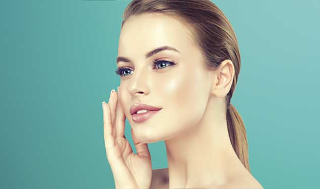 Sofwave ultrasound skin lifting Dublin - woman in profile touching her cheek with one Woman in profile touching her cheek with one hand against a teal background for Sofwave ultrasound skin lifting in Dublin