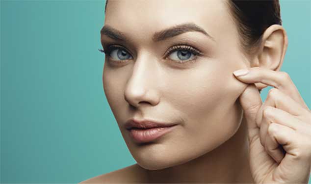 Sofwave ultrasound skin lifting Dublin - woman pinching the skin on her cheek Woman pinching the skin on her cheek for Sofwave ultrasound skin lifting in Dublin